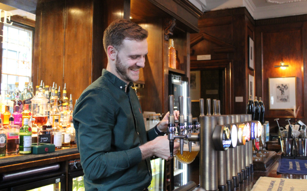 Barman pouring a pint
